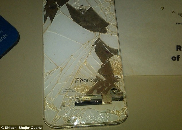 Shibani Bhujle, a marketing manager from New York, claims her iPhone, pictured, spontaneously started melting while placed on her coffee table. There was a sudden smell of burning, she said
